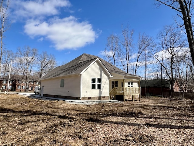 rear view of property featuring crawl space