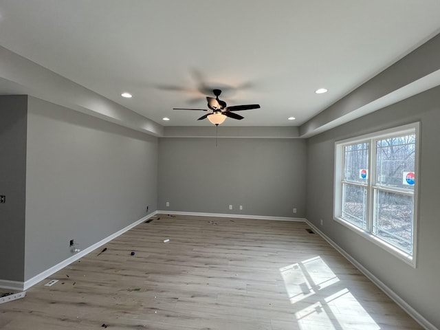 unfurnished room featuring light wood-style flooring, baseboards, and recessed lighting