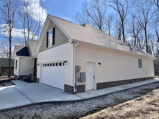 view of home's exterior featuring a garage, driveway, a shingled roof, and crawl space