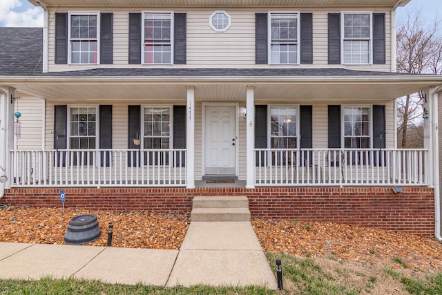 view of front of house featuring a porch and a shingled roof