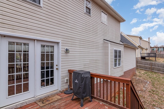 wooden terrace featuring fence