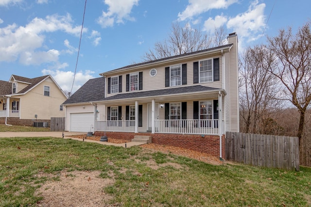 colonial home with fence, a porch, a chimney, a garage, and driveway