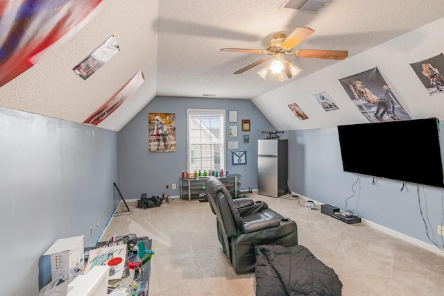 interior space featuring a textured ceiling, a ceiling fan, lofted ceiling, and carpet floors