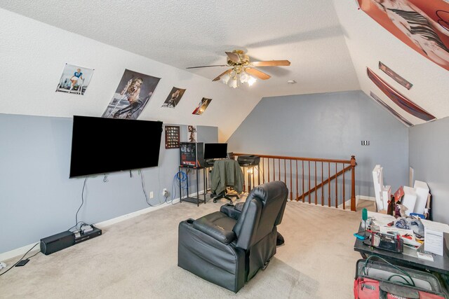 carpeted living area with baseboards, ceiling fan, a textured ceiling, and lofted ceiling