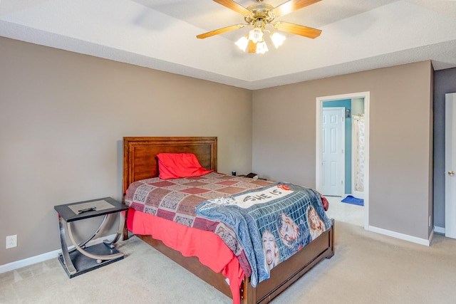 bedroom with light colored carpet, baseboards, and ceiling fan