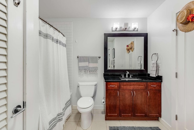 bathroom with tile patterned flooring, toilet, a shower with shower curtain, vanity, and baseboards