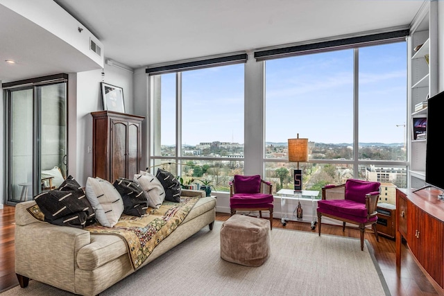 living area featuring a wall of windows and wood finished floors