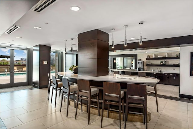 kitchen with light countertops, visible vents, light tile patterned flooring, and open shelves