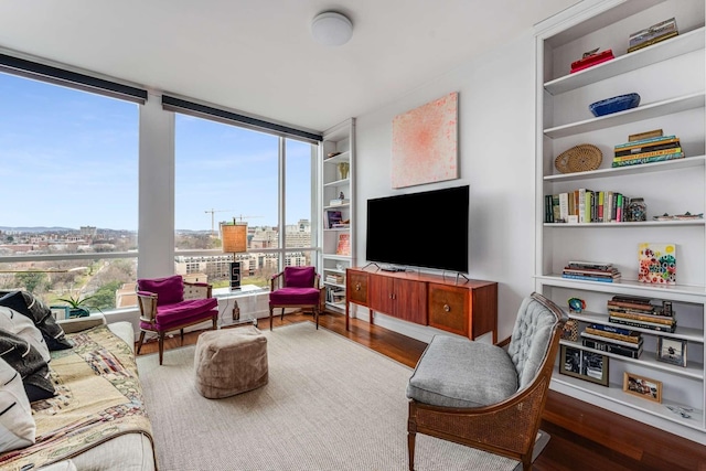 living room featuring built in features and wood finished floors