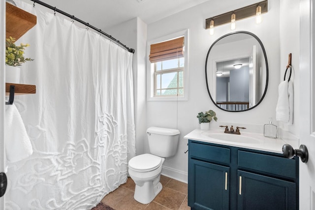 bathroom featuring toilet, vanity, a shower with curtain, baseboards, and tile patterned floors