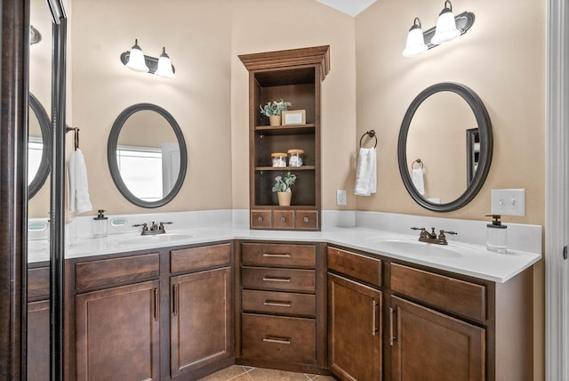 bathroom with double vanity, a sink, and tile patterned floors