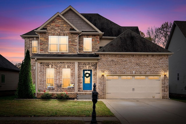 view of front facade featuring brick siding, a yard, a garage, stone siding, and driveway