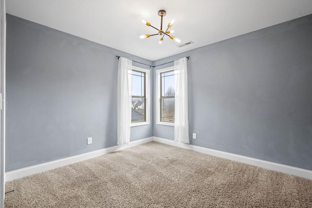 spare room featuring an inviting chandelier, baseboards, visible vents, and carpet flooring