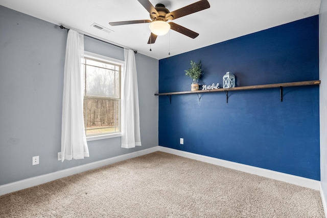 unfurnished room with a ceiling fan, carpet flooring, visible vents, and baseboards