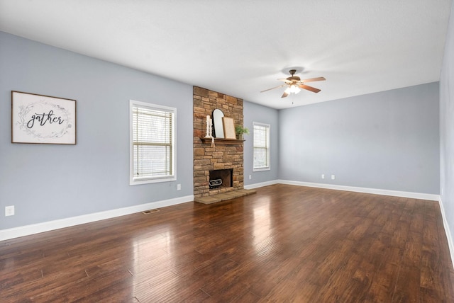 unfurnished living room featuring a fireplace, visible vents, a ceiling fan, wood finished floors, and baseboards