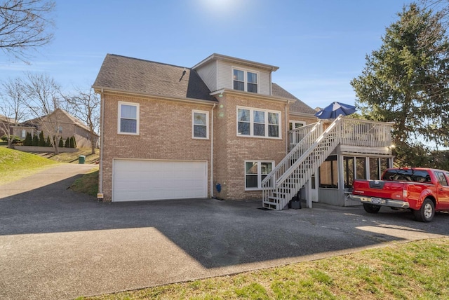 6545 Chessington Dr, Nashville, TN 37221 - rear view of house featuring aphalt driveway, brick siding, roof with shingles, stairway, and an attached garage