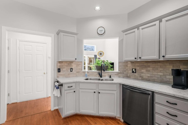 6545 Chessington Dr, Nashville, TN 37221 - kitchen with light stone counters, light wood finished floors, backsplash, a sink, and dishwasher