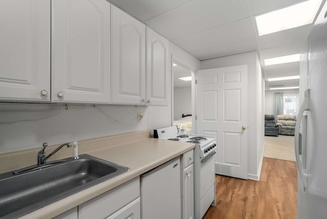 6545 Chessington Dr, Nashville, TN 37221 - kitchen with light countertops, light wood-style floors, white cabinets, a sink, and white appliances