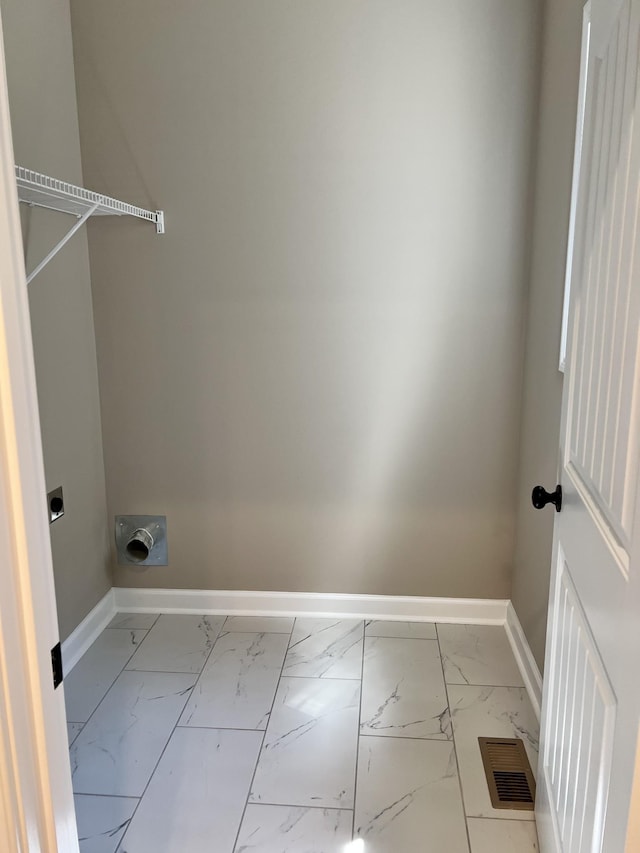 laundry room featuring laundry area, visible vents, baseboards, marble finish floor, and hookup for an electric dryer