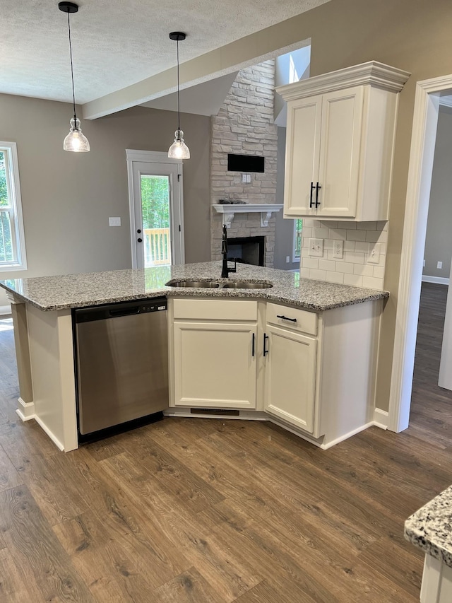 kitchen with white cabinets, dishwasher, backsplash, dark wood-style flooring, and a sink