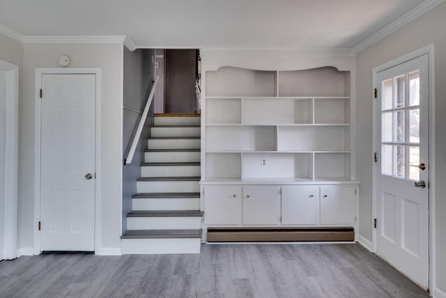 interior space with ornamental molding, stairway, baseboards, and wood finished floors