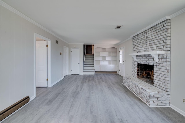 unfurnished living room featuring stairs, a baseboard radiator, wood finished floors, and visible vents