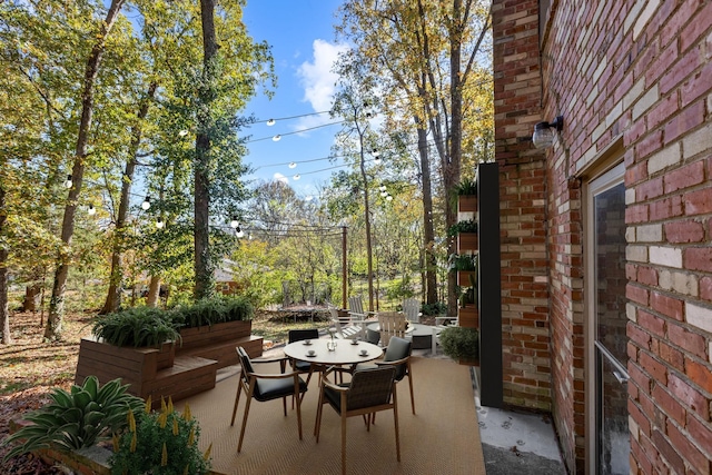 view of patio / terrace featuring a trampoline and outdoor dining space