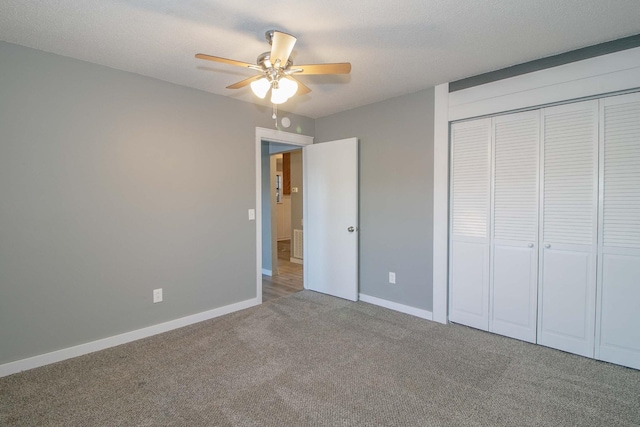 unfurnished bedroom with carpet floors, a closet, visible vents, a textured ceiling, and baseboards