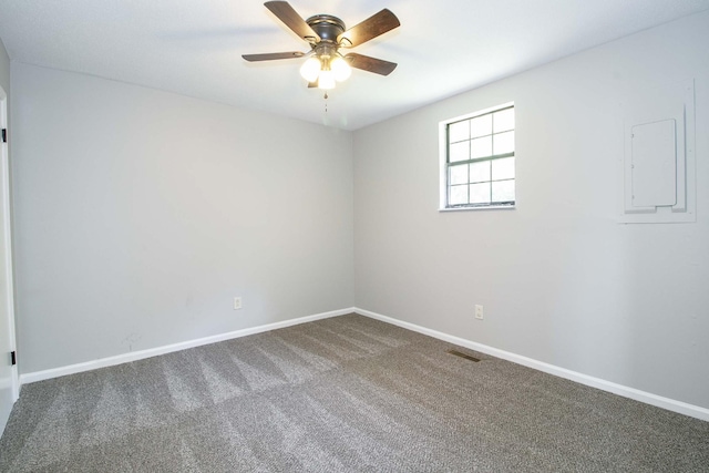 carpeted spare room with ceiling fan, visible vents, and baseboards