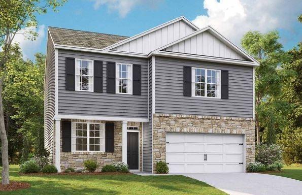 craftsman-style home with board and batten siding, stone siding, and an attached garage