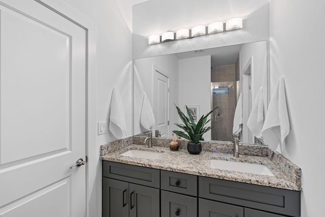 bathroom with double vanity, a sink, and a shower stall