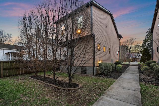 view of side of property featuring fence