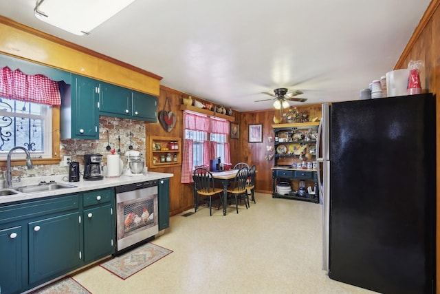 kitchen featuring a ceiling fan, dishwashing machine, freestanding refrigerator, light countertops, and a sink