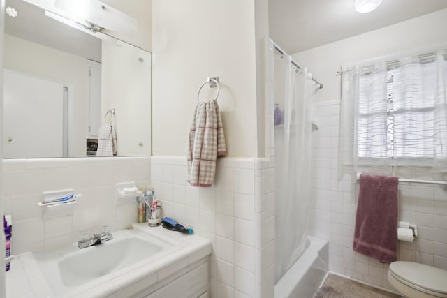 full bathroom featuring tile patterned flooring, tile walls, toilet, and shower / bath combo with shower curtain