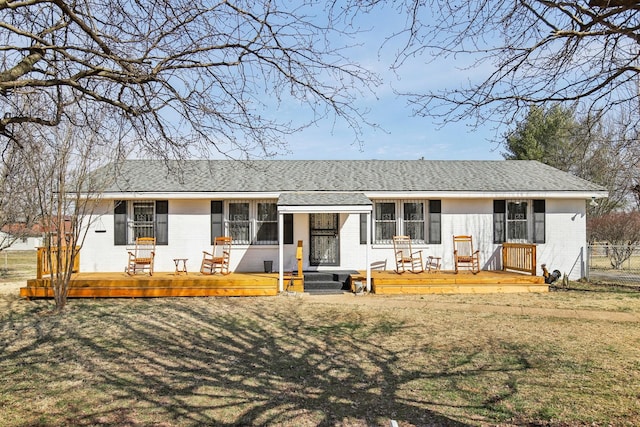 single story home with brick siding, fence, a wooden deck, and roof with shingles