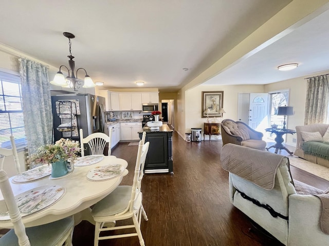 dining room featuring a chandelier and dark wood-style flooring