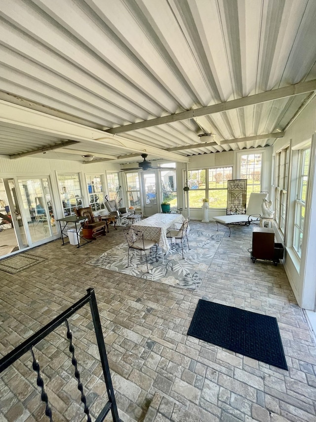 unfurnished sunroom with beam ceiling