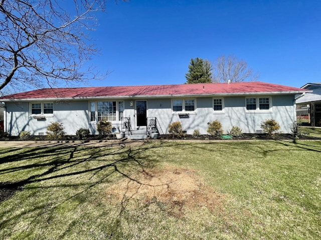 view of front facade with metal roof and a front yard