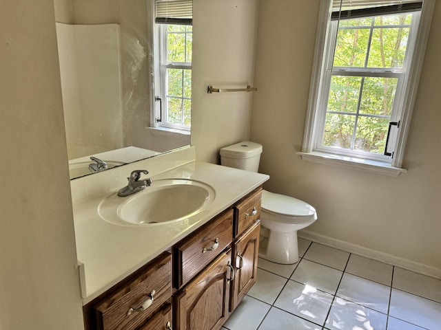 bathroom with toilet, tile patterned flooring, baseboards, and vanity