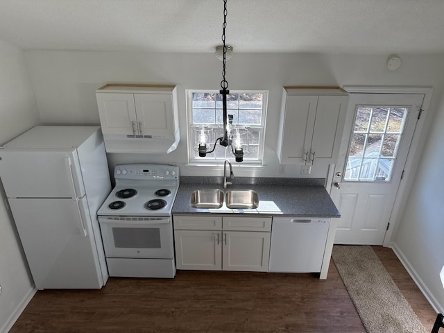 kitchen featuring under cabinet range hood, white appliances, a sink, white cabinetry, and dark wood-style floors