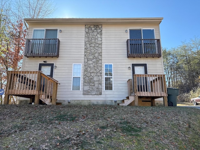 rear view of house featuring a balcony