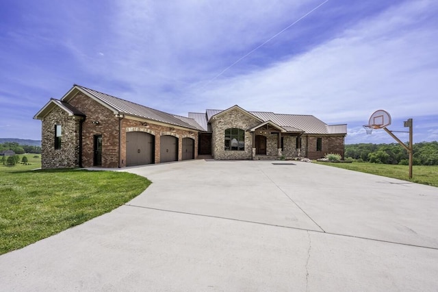 french country home featuring an attached garage, metal roof, concrete driveway, and brick siding