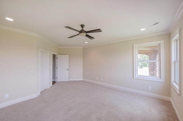 empty room featuring recessed lighting, light colored carpet, visible vents, ornamental molding, and baseboards