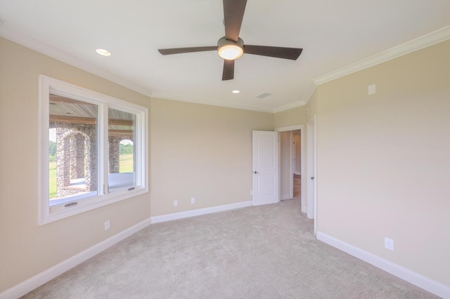 empty room with ornamental molding, recessed lighting, light colored carpet, and baseboards