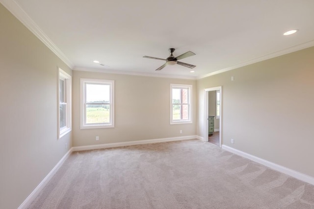 unfurnished room featuring crown molding, recessed lighting, light colored carpet, and baseboards