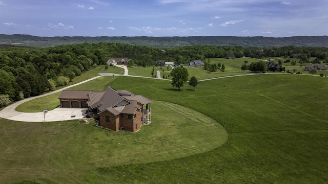 drone / aerial view with a wooded view