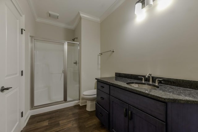 bathroom with toilet, a stall shower, and crown molding