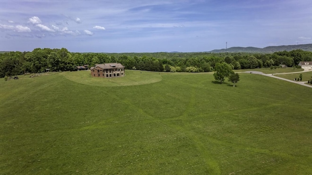 birds eye view of property featuring a view of trees