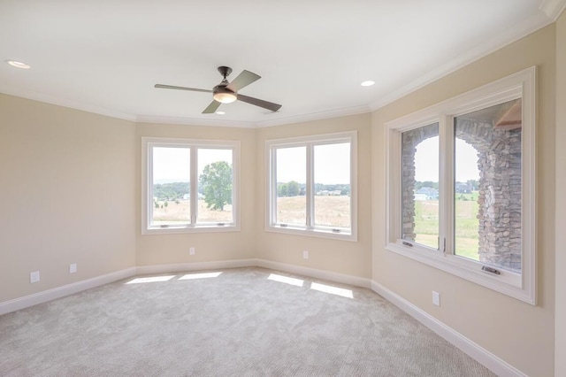 unfurnished room with ornamental molding, light carpet, and baseboards