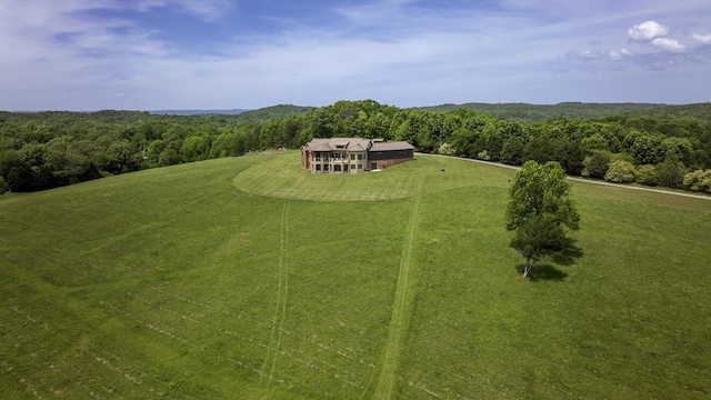 drone / aerial view featuring a forest view